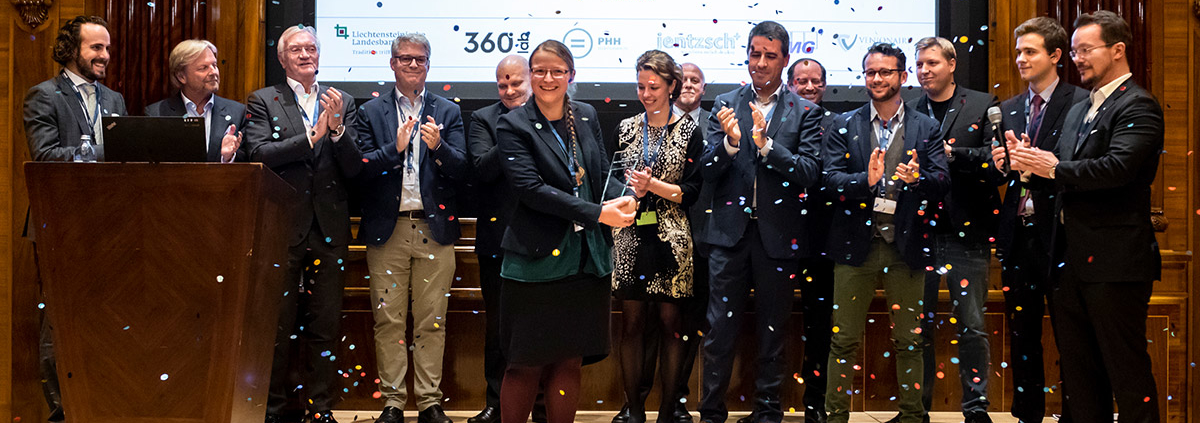 Fiona receiving the trophy for Digital Health Champion 2018, while sponsors, jury members and startup finalists are congratulating.